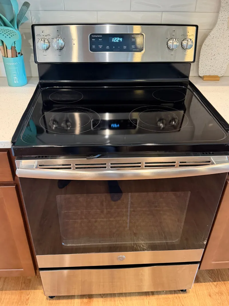 The same kitchen stove after cleaning, with a clear glass top