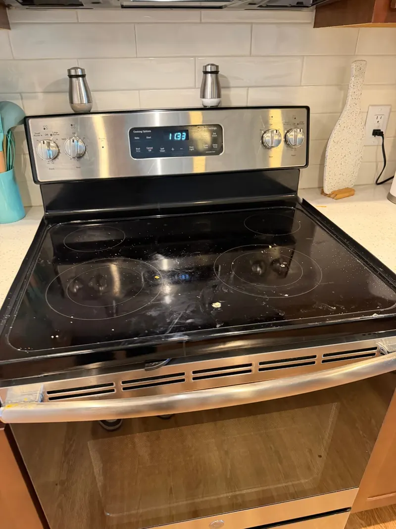 Kitchen stove top before cleaning, with cooked on spills